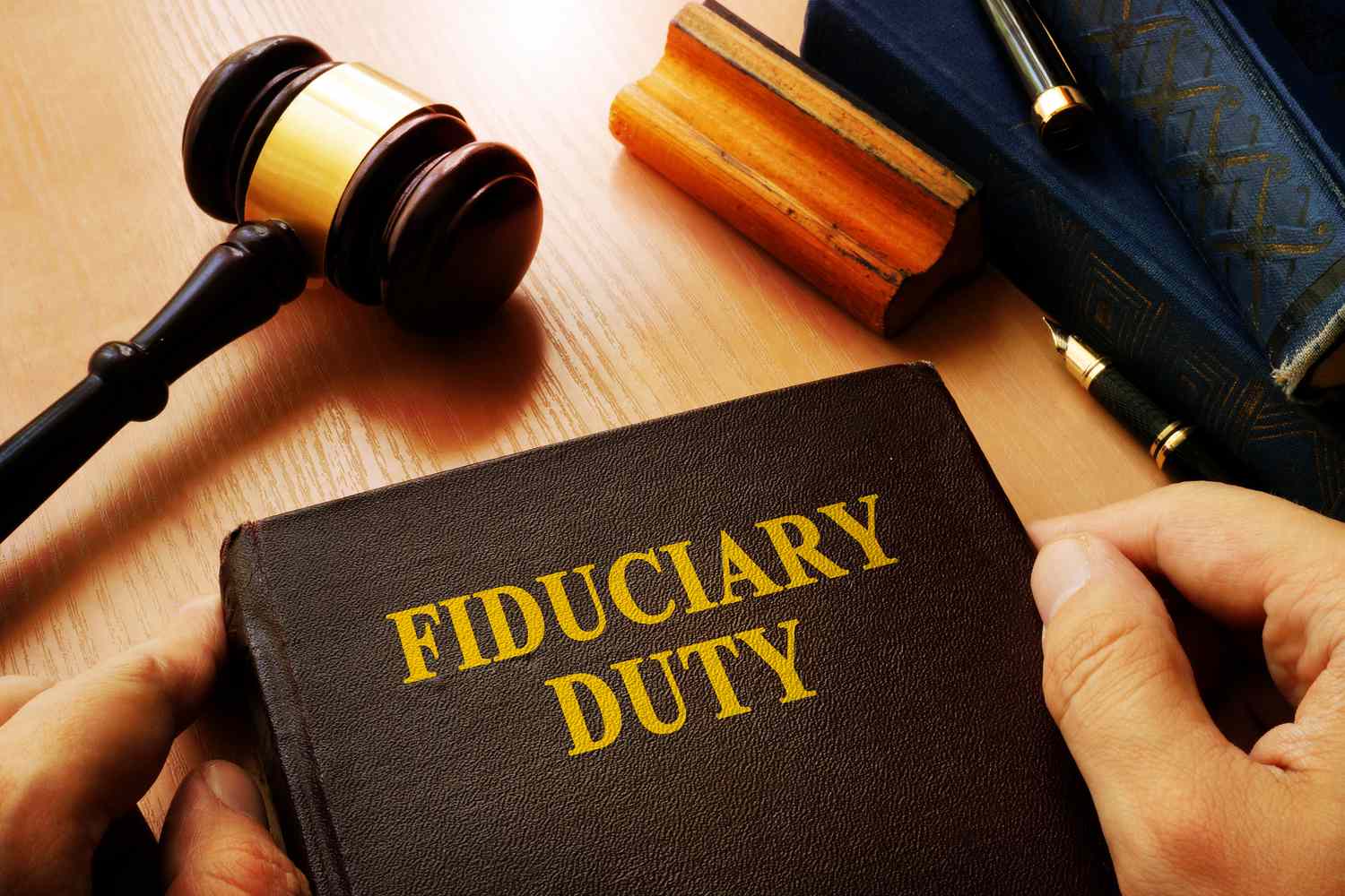 A judge's gavel and a book about Fiduciary Duty