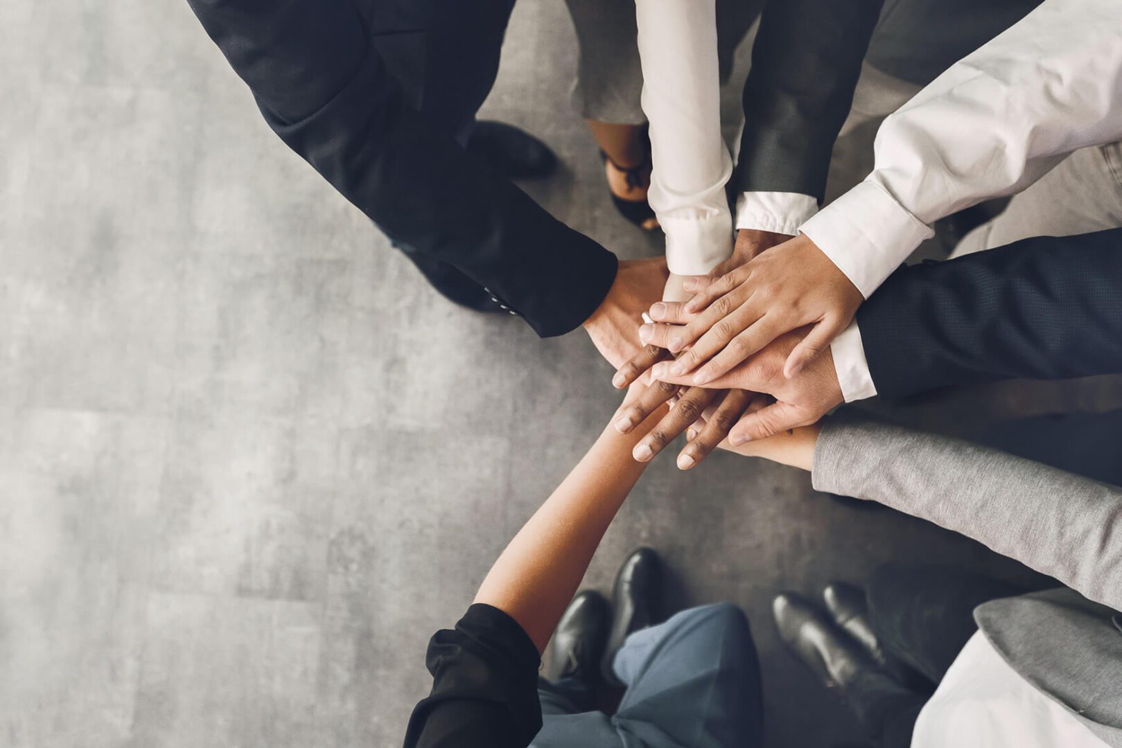 Team members stacking hands together