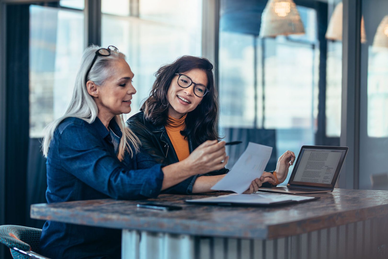 Women reviewing documents together